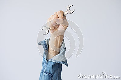 1 may labor day, man hand with wrench tool on grey background Stock Photo