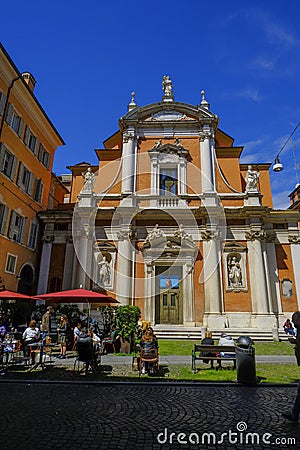 May 2022 Modena, Italy: Church of San Giorgio and people in cafe in the street on a sunny day Editorial Stock Photo