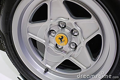 May 2022 Modena, Italy: Ferrari sportscar tire close-up. Ferrari details. Ferrari logo icon Editorial Stock Photo