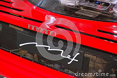 May 2022 Modena, Italy: Red Ferrari sportscar back part with spoiler, headlights and Ferrari logo icon close-up Editorial Stock Photo