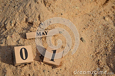 May 01, Number cube with Sand background. Stock Photo