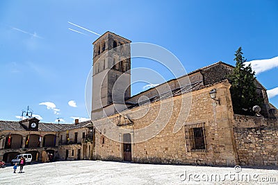 May 2019, Pedraza, Castilla Y Leon, Spain: tourists near Iglesia San Juan Bautista in Plaza Mayor. Editorial Stock Photo