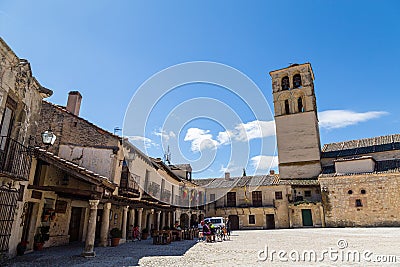 May 2019, Pedraza, Castilla Y Leon, Spain: tourists near Iglesia San Juan Bautista in Plaza Mayor. Editorial Stock Photo
