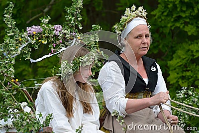 May Queen and her escort in medieval May Day reenactment Editorial Stock Photo