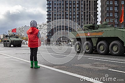 May 4, 2021, Russia, Moscow. Rehearsal of the victory parade in the Great Patriotic War. A child looks at army Editorial Stock Photo