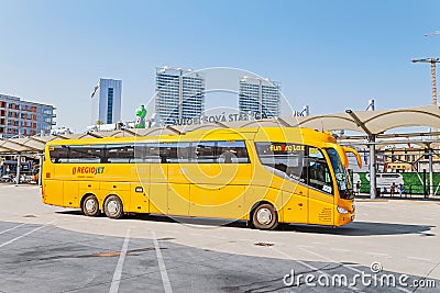yellow buse of Regiojet company at the boarding of passengers at the bus station of Bratislava Editorial Stock Photo