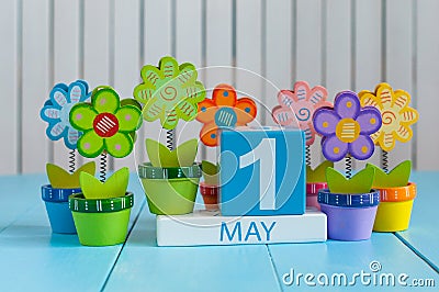 May 1st. Image of may 1 wooden color calendar on white background with flowers. Spring day, empty space for text Stock Photo