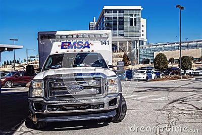 May 7, 2023, Tulsa OK Ford Emsa Ambulance parked in lot across from hospital with cross on sunny day Editorial Stock Photo