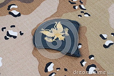 May 12, 2018. US ARMY Specialist rank patch on desert camouflage uniform background Editorial Stock Photo