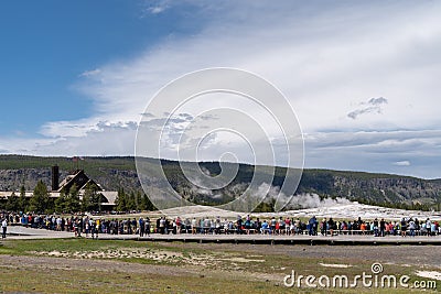 Yellowstone, Wyoming: Crowds of tourists and visit Old Faithfull before it erupts Editorial Stock Photo