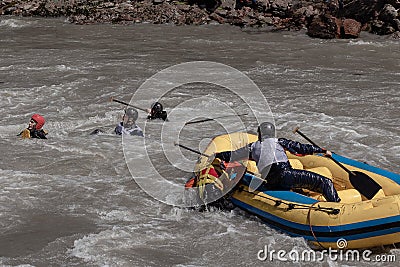 Rafting, brave and courageous people conquer water obstacles on a mountain river on rafts. Editorial Stock Photo