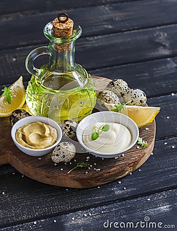 Mayonnaise and ingredients for cooking - olive oil, quail eggs. lemon, mustard and spices Stock Photo