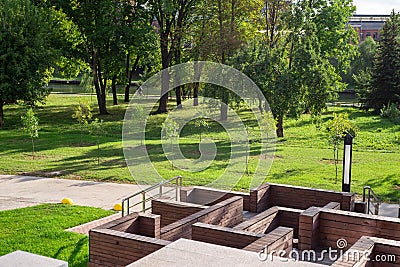 A maze of brown wooden walls, a green-yellow autumn park Stock Photo