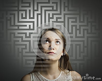Maze. Girl in white solving a problem. Stock Photo