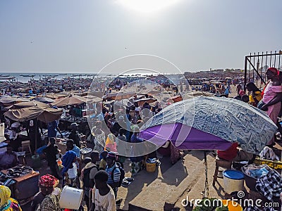 MBour, Senegal- April 25 2019: Unidentified Senegalese men and women at the fish market in the port city near Dakar. There are Editorial Stock Photo