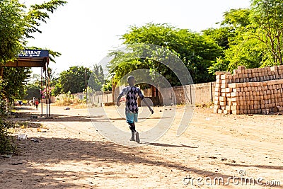 Poor african senegalese child walking street looking for food. Talibe koran school Editorial Stock Photo