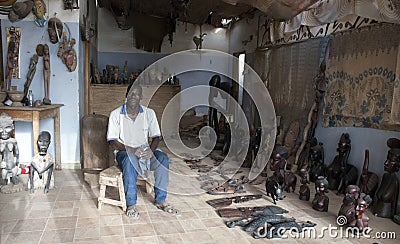 Mbour, Senegal, handcrafts seller posing inside his small souvenir shop Editorial Stock Photo