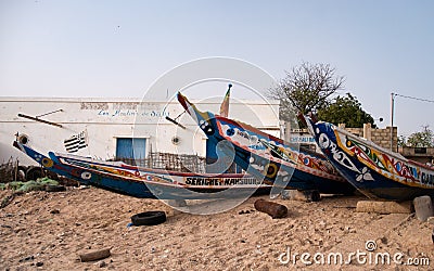 Mbour, Senegal: Colourful fishing boats stranded in the sand Editorial Stock Photo