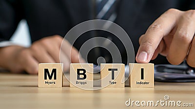 MBTI,Myers-Briggs Type Indicator.Psychological and personality test concept.Businessman and MBTI word on wood cubes Stock Photo