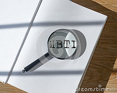 MBTI test of personality types. Psychology concept. Book and magnifier Stock Photo