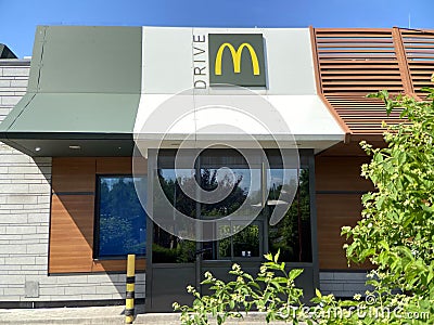 McDonald`s logo sign. McDonald`s Drive restaurant building Editorial Stock Photo