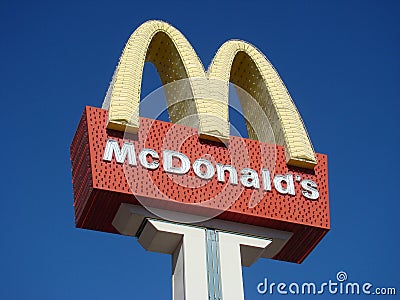 McDonald`s sign with neon golden arches Editorial Stock Photo