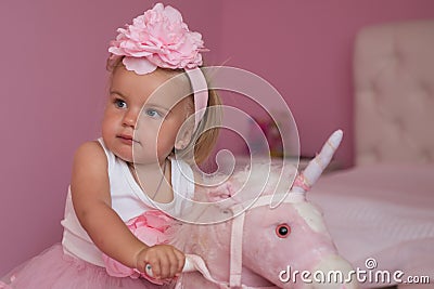 Me and my horse. Small child wear hair band. Small blond girl ride toy horse. Little girl with long hairstyle. Hair Stock Photo