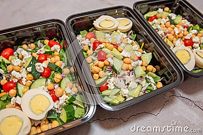 Meal prep protean salad in black meal prep containers Stock Photo