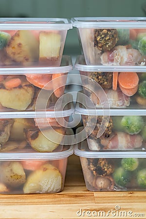 Meal prep. Stack of home made roast dinners. Vertical. Stock Photo