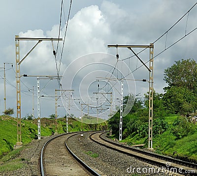 Railway curve with electric poles Stock Photo