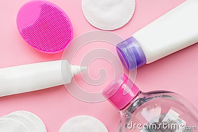 Means for washing face and problem skin care. Silicone facial brush cotton pads jar of micellar water anti-acne cream isolated Stock Photo
