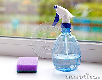 Means for washing Windows. Bottle of spray and a sponge. Closeup Stock Photo