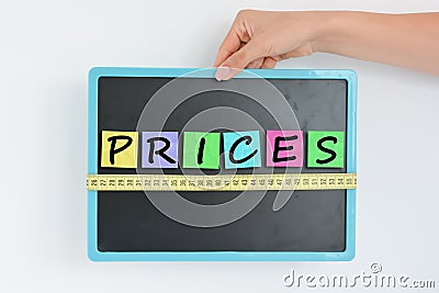 Measurement of prices concept on blackboard Stock Photo
