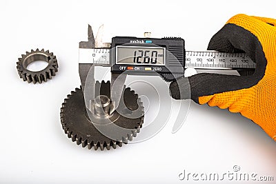 Measuring the gears with a caliper. Engineering work in the laboratory Stock Photo