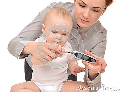 Measuring glucose level blood test from diabetes child baby Stock Photo