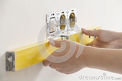 Measuring the level of electrical outlets Stock Photo