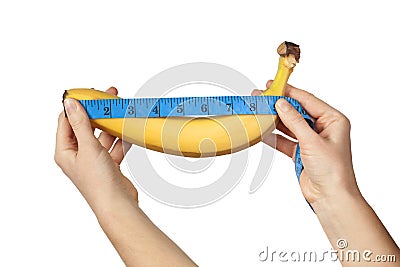 Measuring the size of a banana as a symbol of the male penis isolated on white background. Big dick length. Strong erection and Stock Photo