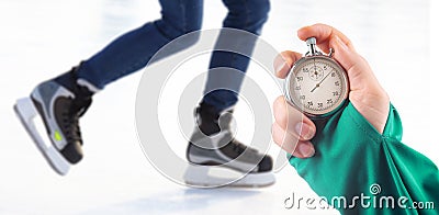 Measuring speed on skates with a stopwatch. hand with a stopwatch on the background of the legs of a man skating on an ice rink Stock Photo