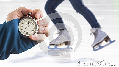 Measuring speed on skates with a stopwatch. hand with a stopwatch on the background of the legs of a man skating on an ice rink Stock Photo