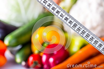 Measuring tape and Fresh vegetable and fruits in the background. Healthy diet concept Stock Photo