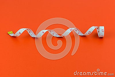 Measuring tape on red background Stock Photo