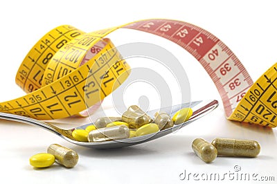 Measuring tape with tablets Stock Photo