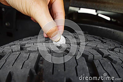 Measuring tire depth Stock Photo