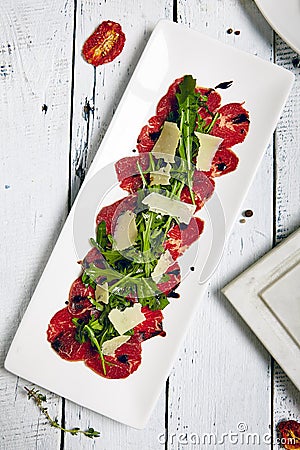 Meat Carpaccio with Rocket Salad Stock Photo