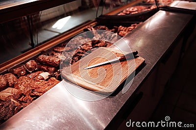 A table with a meat cutting knife in meat shop Stock Photo