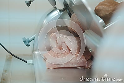 Meat cutting slicing machine in food processing factory Stock Photo