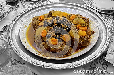 Meat dish with plum, dried pineapple and almonds. One of the most famous Moroccan dishes. Stock Photo
