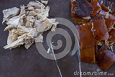 Meat dish served for buffet, catering service on celebration. Fried pork cut for plate servings. Kitchen tongs. Stock Photo