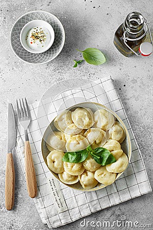 Meat dumplings - russian pelmeni, ravioli with meat on a white plate. Flat lay composition Stock Photo