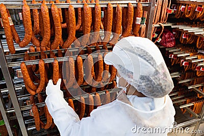 The meat factory women handeling smoked sausages Editorial Stock Photo